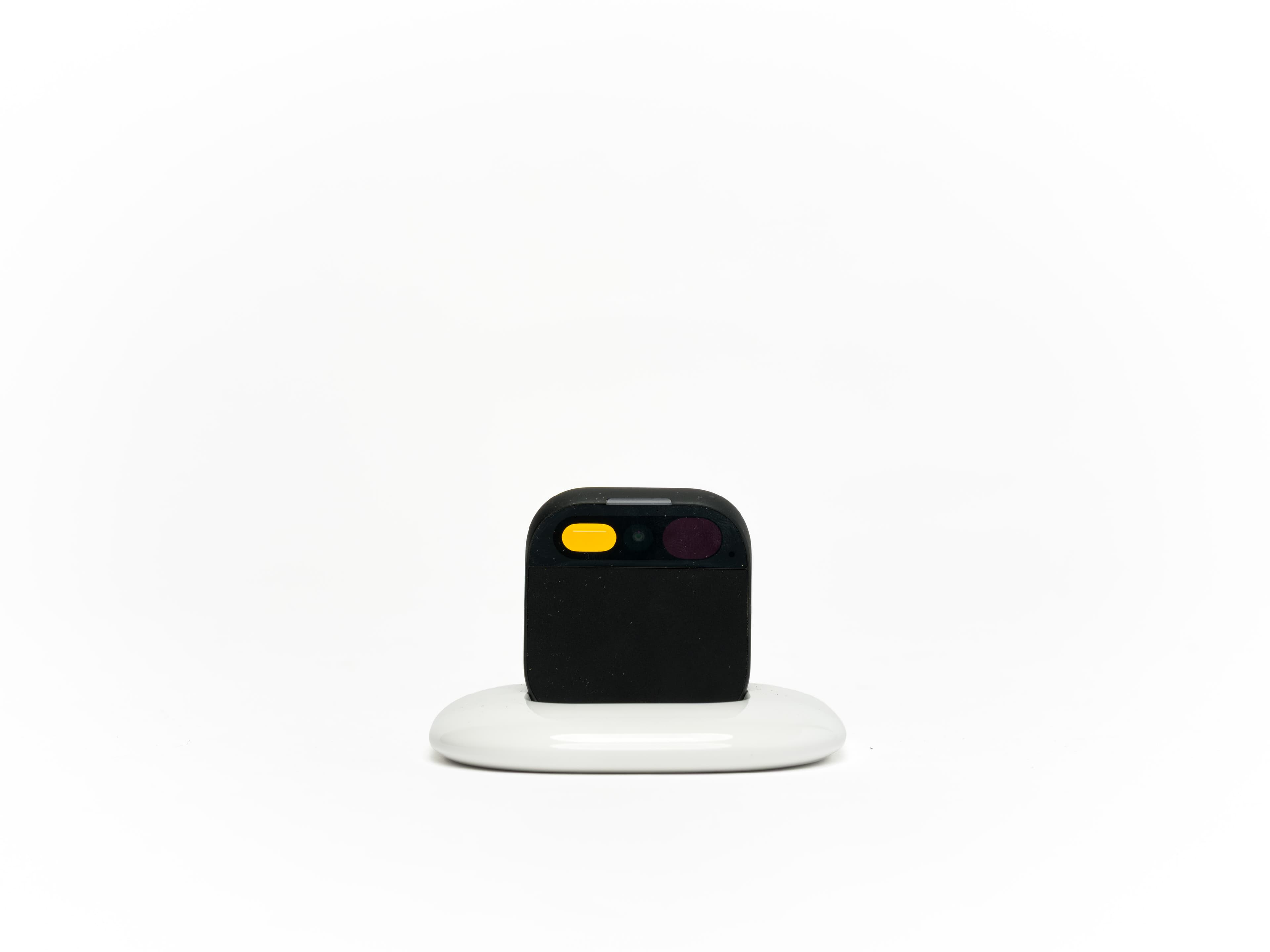 Humane AI pin on its charging dock